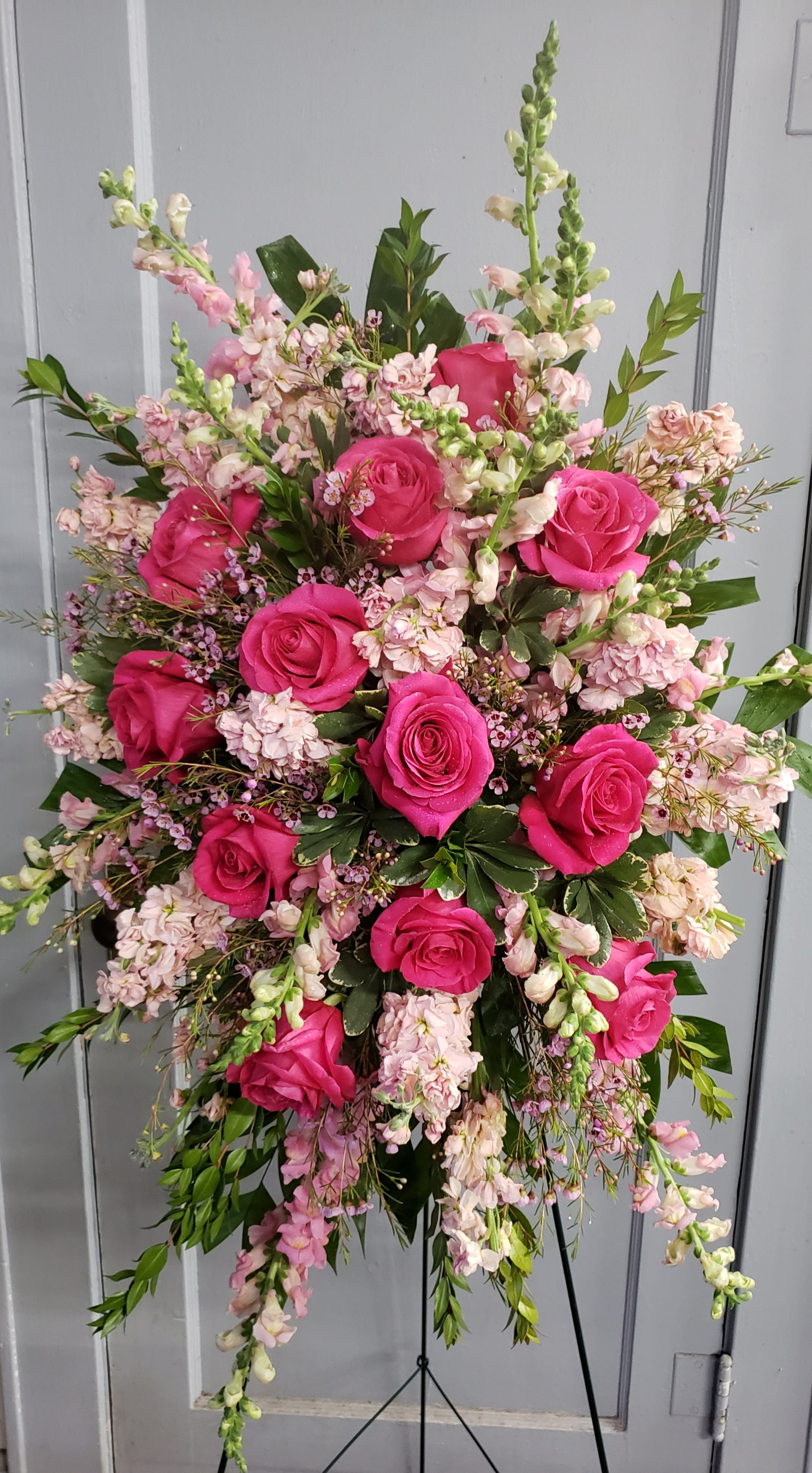 Pleasing Pink Tribute  - A beautiful spray of fragrant flowers in shades of pink. Approximately 30 inches long and24 inches wide. Placed on a 48 inch easel.