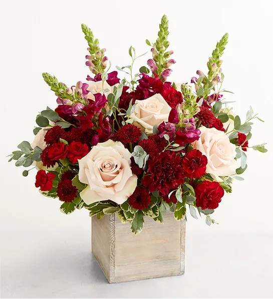 Harvest Dreams - This is the bouquet they’ve been dreaming of: rustic yet refined, organic and eye-catching. Pale roses nestle among burgundy blooms and airy greenery artfully arranged in a crescent shape. It arrives in a wooden cube that adds to its pastoral charm