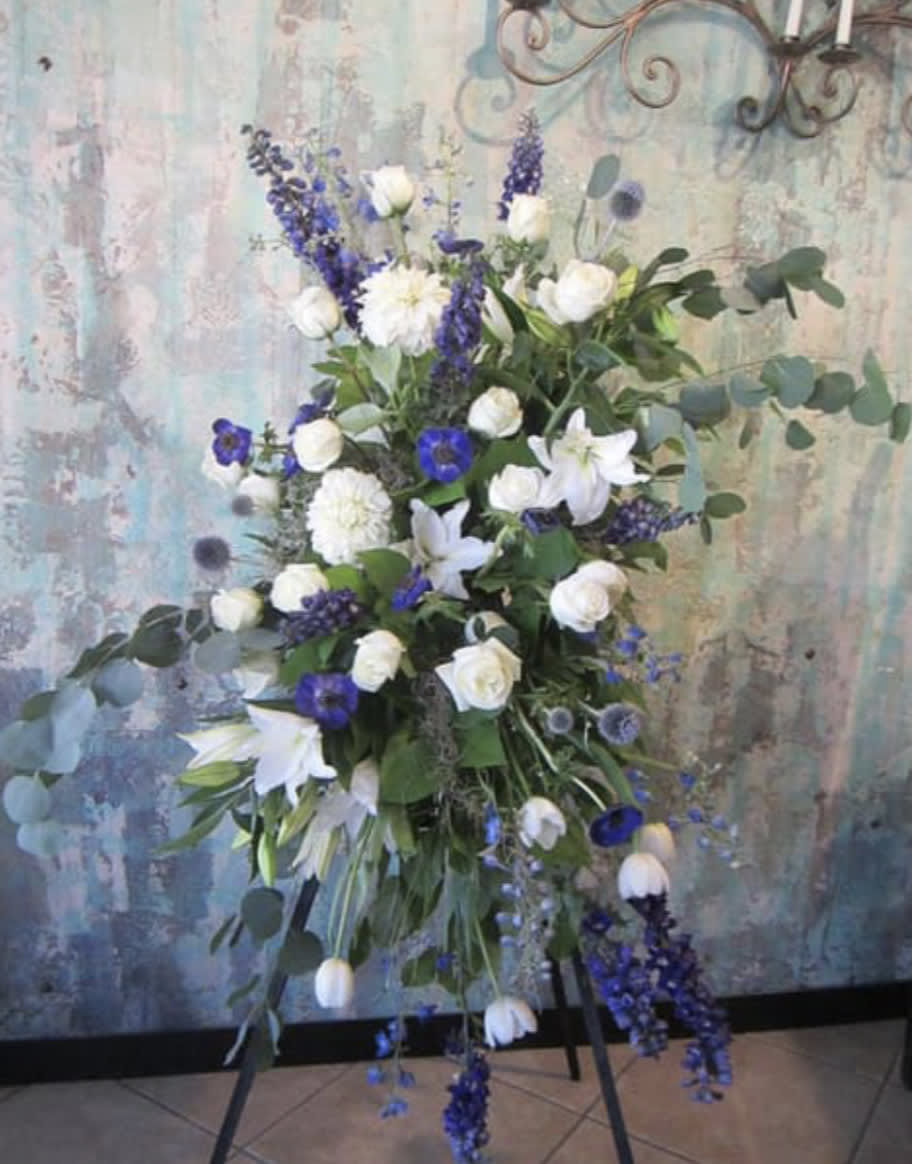 Tall white and purple floral spray on a stand