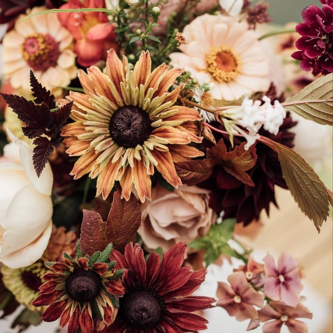 Autumn bouquet with large daisy-like blooms in cream, peach, and burgundy