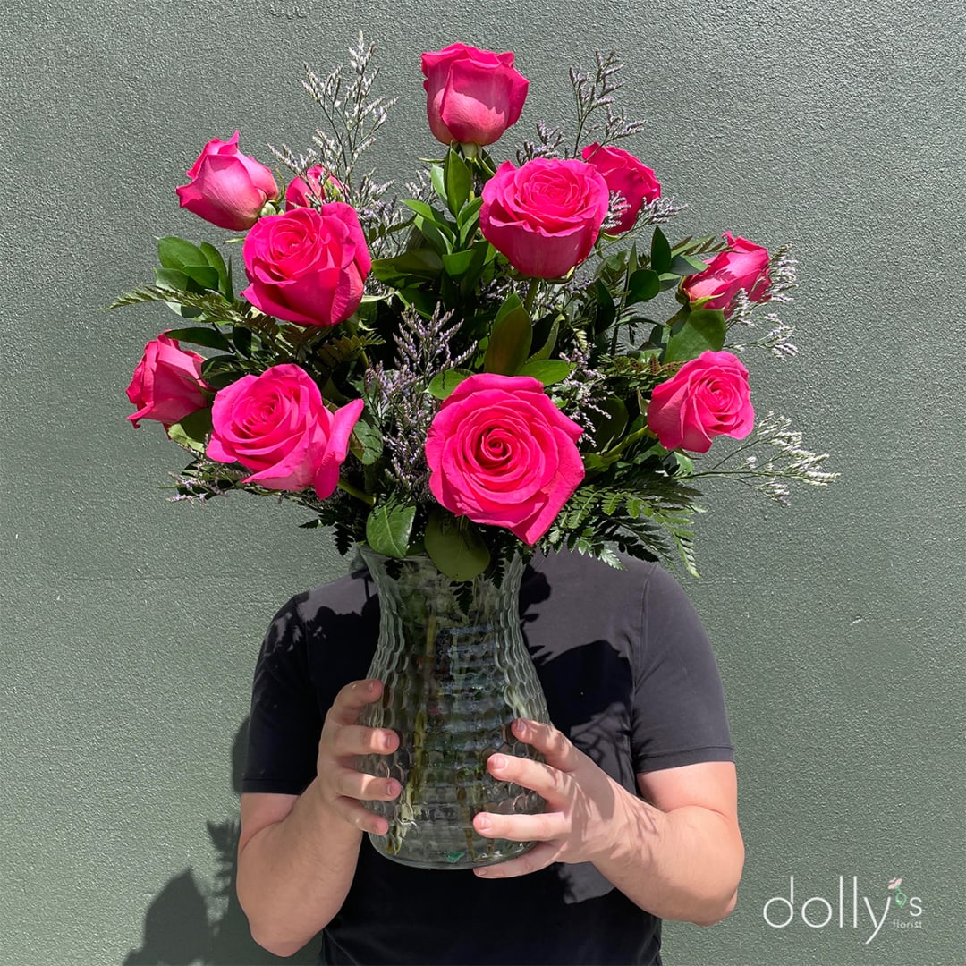 Pink roses arranged in a clear glass vase