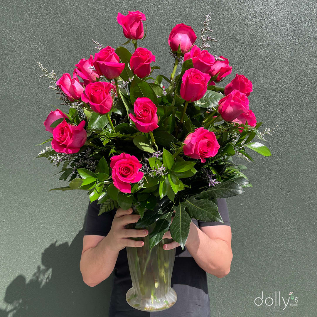Bouquet of hot pink roses in a clear glass vase