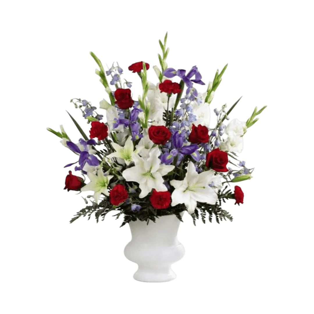 Cherished Farewell - Cherished Farewell Arrangement is an elegant display of patriotic beauty to honor your loved one at their final farewell service. Red roses, red carnations, white gladiolus, light blue delphinium, blue iris, white Oriental lilies, white Asiatic lilies and lush greens are elegantly arranged in a white plastic urn to create a stunning way to say your last goodbye.
