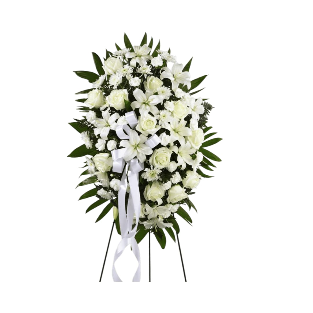 Exquisite Tribute Standing Spray - Exquisite Tribute Standing Spray is an elegant display of  sweet serenity. White roses, Asiatic lilies, chrysanthemums and mini  carnations are artfully arranged amongst emerald palm fronds and lush  greens. Accented by white satin ribbon and standing on a wire easel,  this standing spray is an outstanding way to honor the life of your  loved one.