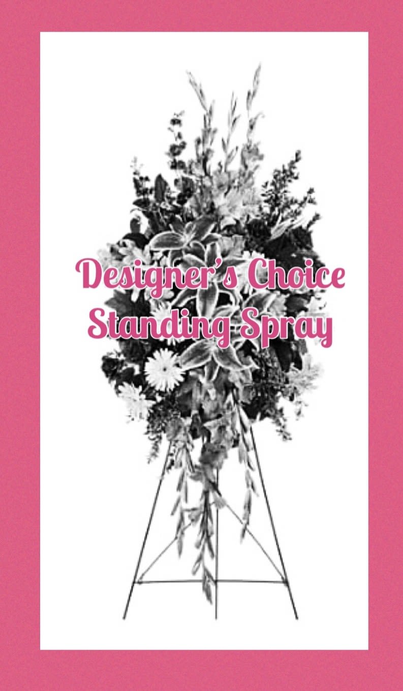 Standing spray on an easel with mixed flowers and greenery