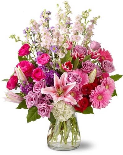 Mixed pink and purple bouquet in a clear glass vase