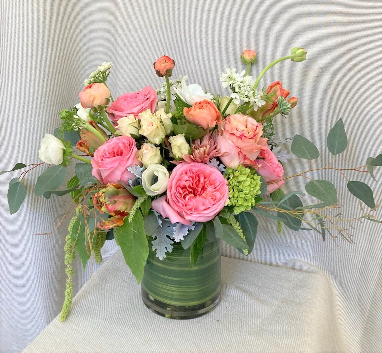 Pink and peach rose bouquet in a glass vase