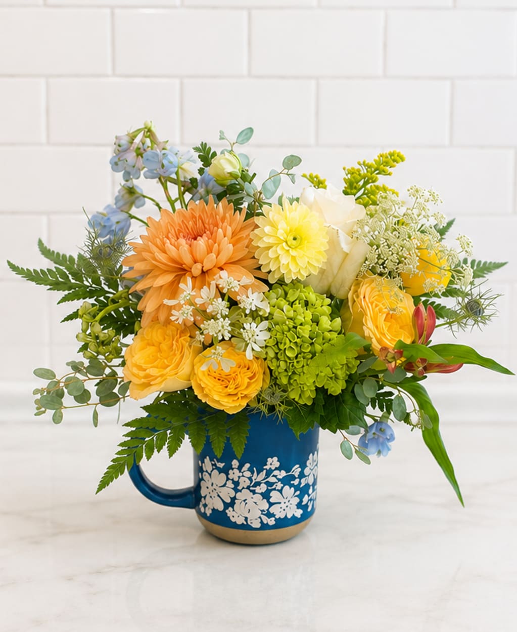 Teacher’s Favorite - This arrangement has been specifically priced to show our gratitude for your favorite scholar or educator in your life!  Flowers for today, a favorite mug for tomorrow. Our deluxe keepsake mug arrangement features cheerful seasonal blooms designed in a charming mug—the perfect desk companion for teachers and students alike.  