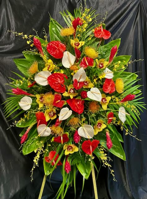 Large tropical floral spray with red and white anthuriums and yellow orchids