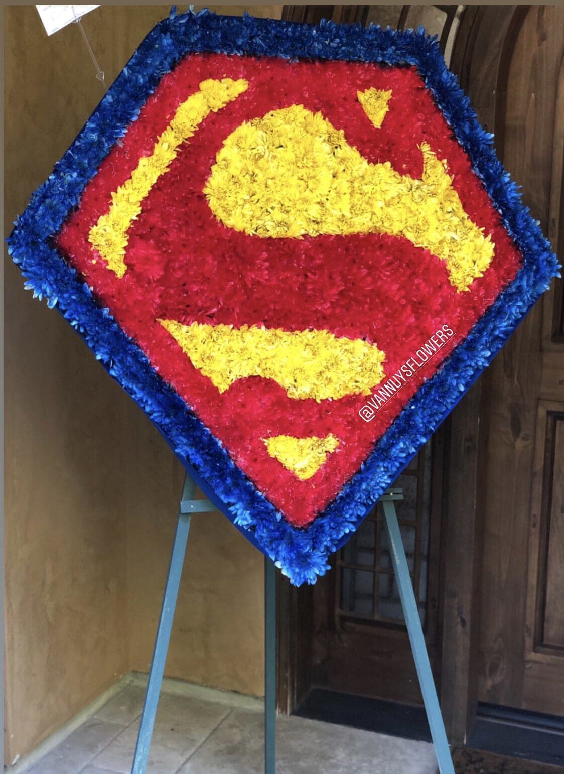 Superman logo floral tribute on an easel