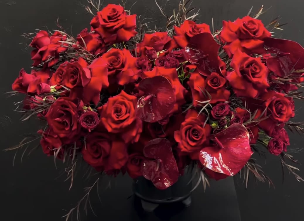 RAVISHING RED - THIS ELEGANT DESIGN SHOWCASES THE BEAUTY OF VELVETY DEEP RED ROSES, STRIKING RED ANTHERIUM AND OTHER DEEP RED SPRAY ROSES PERFECT FOR EXPRESSING LOVE AND PASSION, WHILE MAKING A LASTING IMPRESSION!