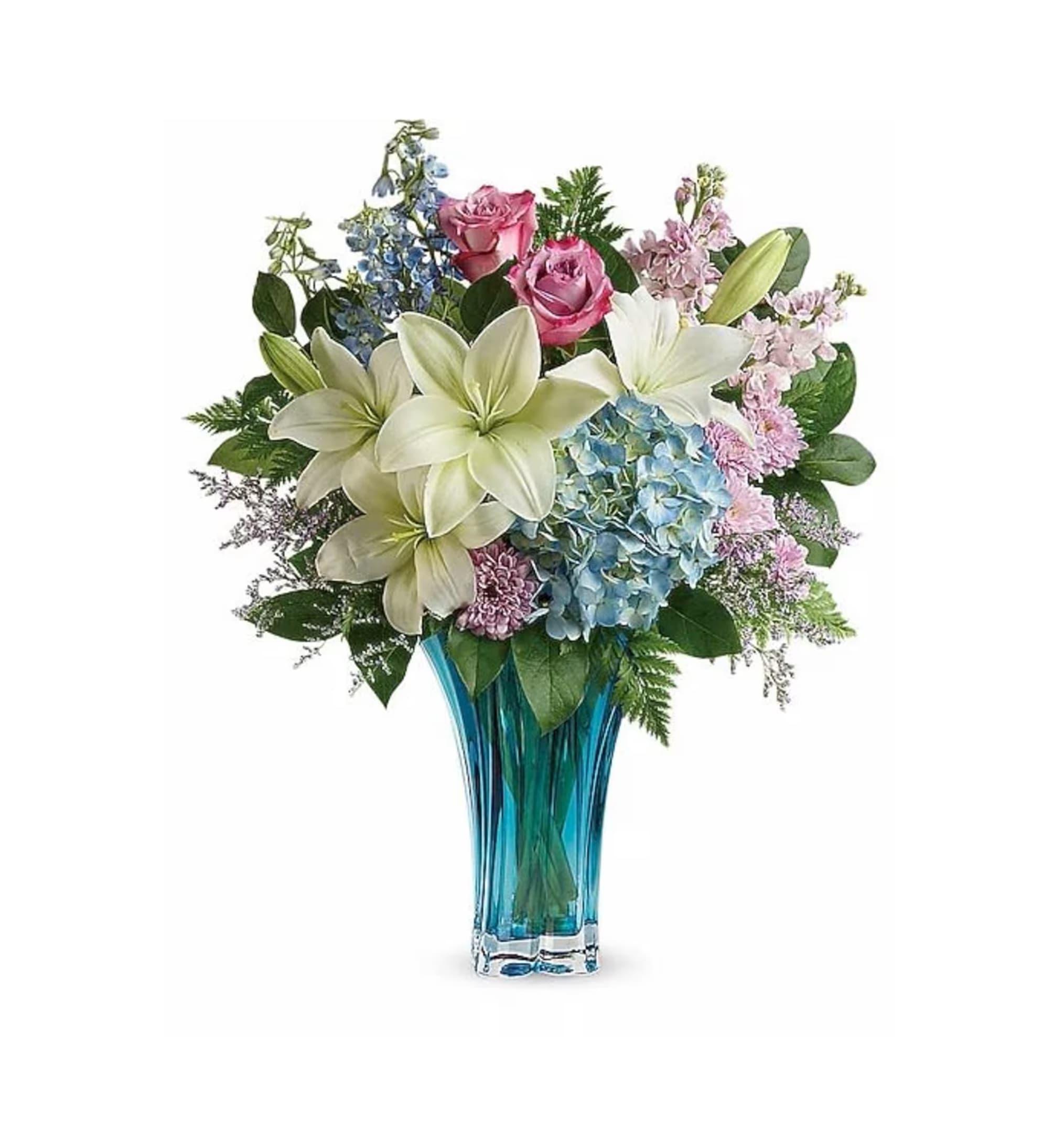 Bouquet of lilies, roses, and hydrangeas in a blue glass vase