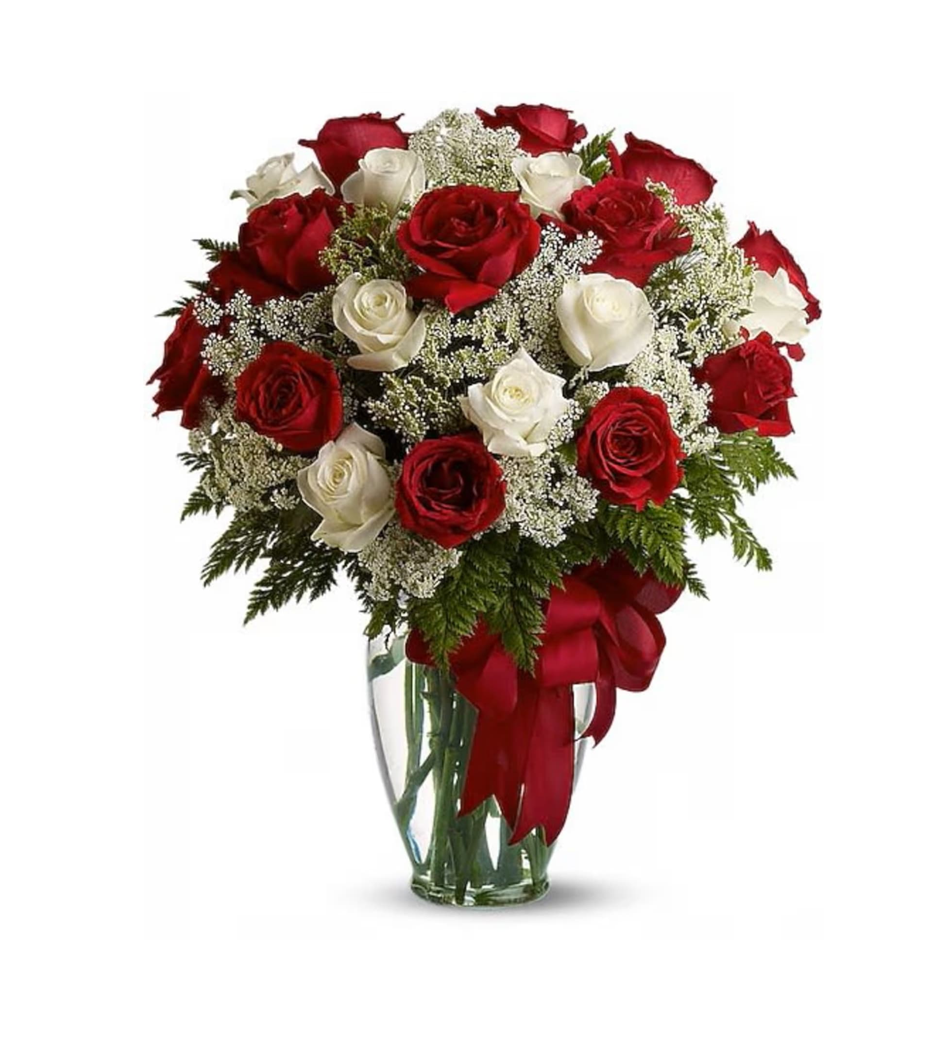 Bouquet of red and white roses in a clear glass vase with a red ribbon