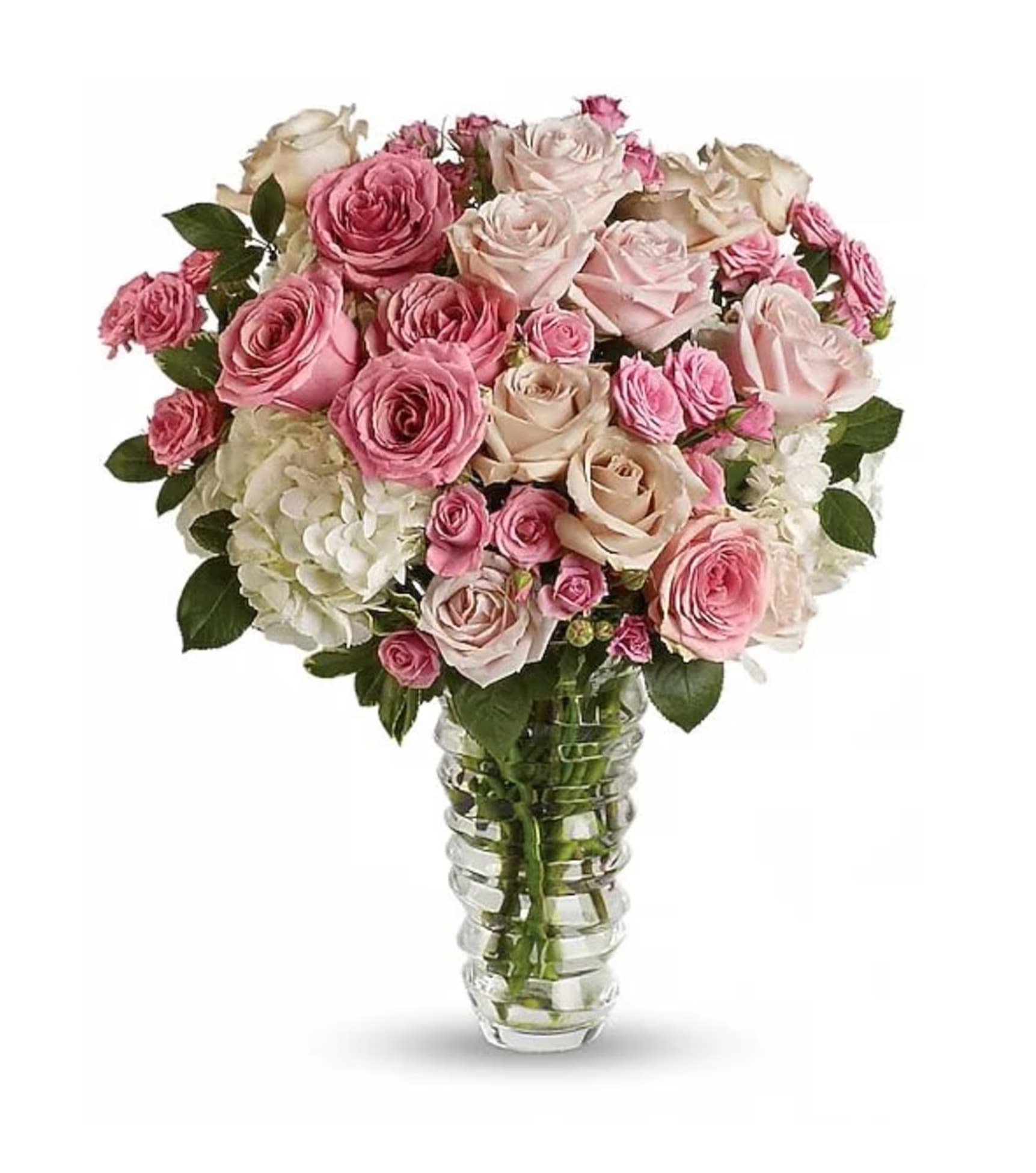Pink and cream roses arranged in a clear glass vase