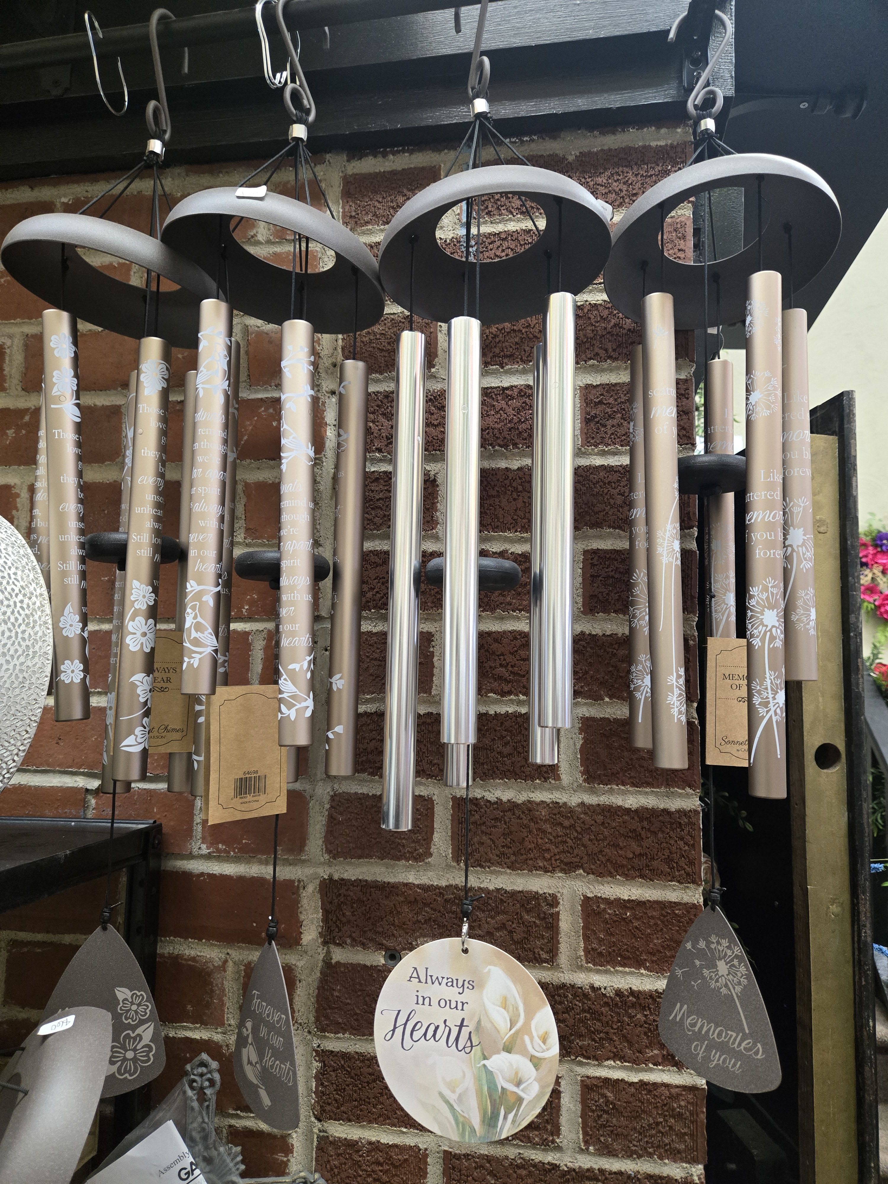 Hanging memorial wind chimes with engraved tubes and heart-shaped tags
