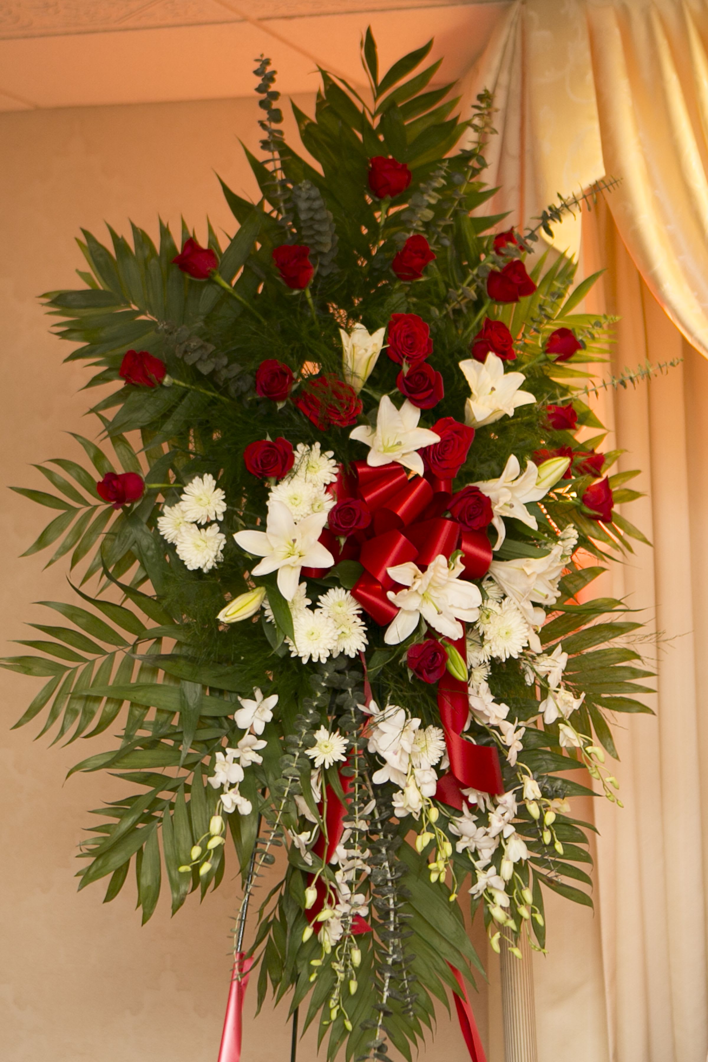 Tall standing floral spray with red roses and white lilies