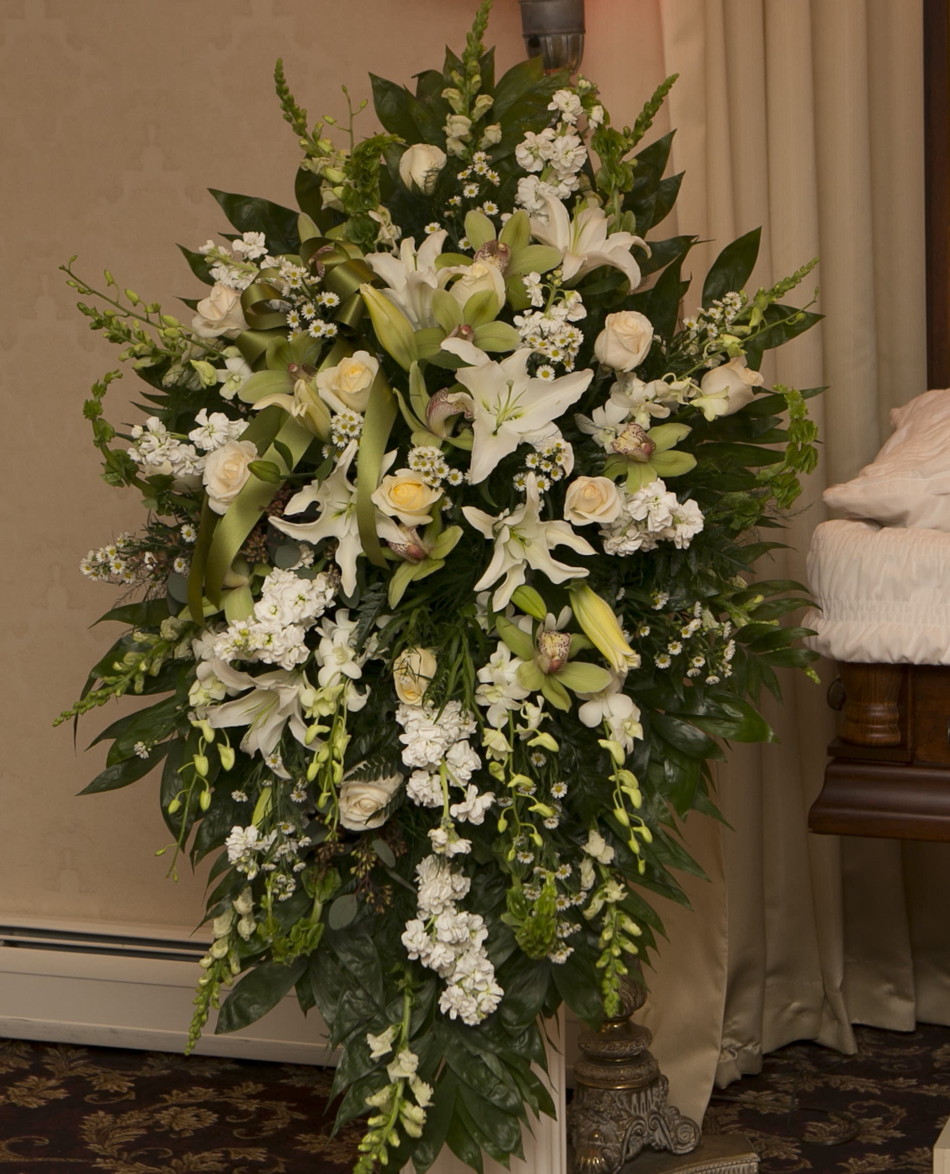 Large white floral standing spray with lilies and roses