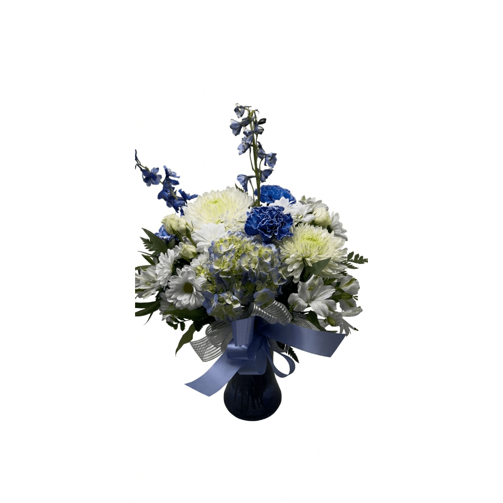 Blue and white mixed flower arrangement in a dark vase with ribbon