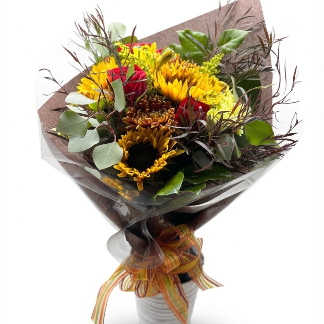 Bouquet of yellow and red flowers wrapped in brown paper with a striped ribbon