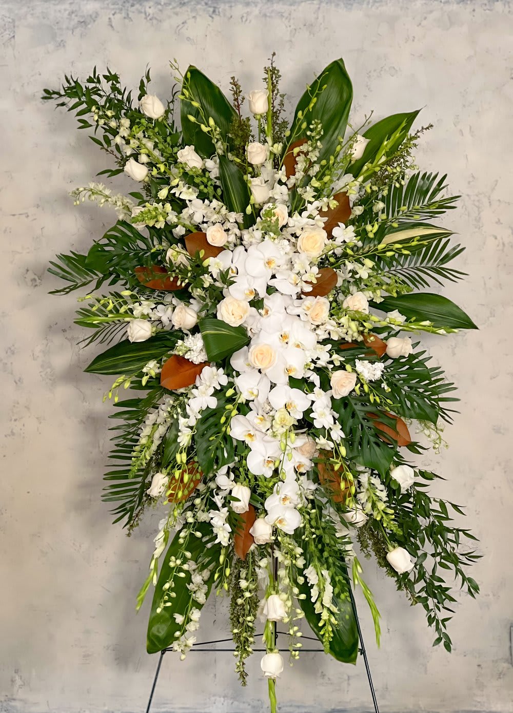 Large white floral standing spray with orchids and roses