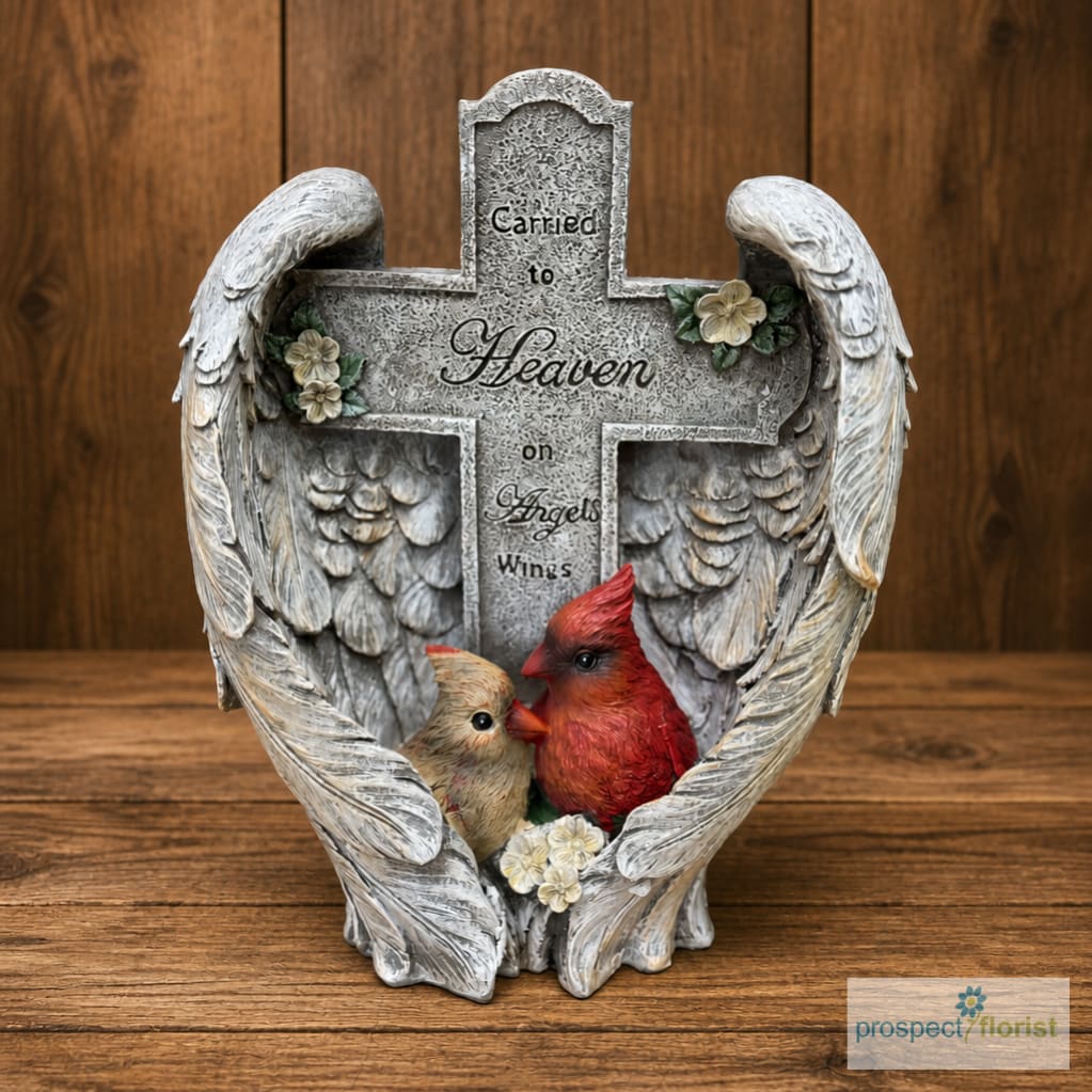 Angel-wing memorial cross with two birds and small flowers