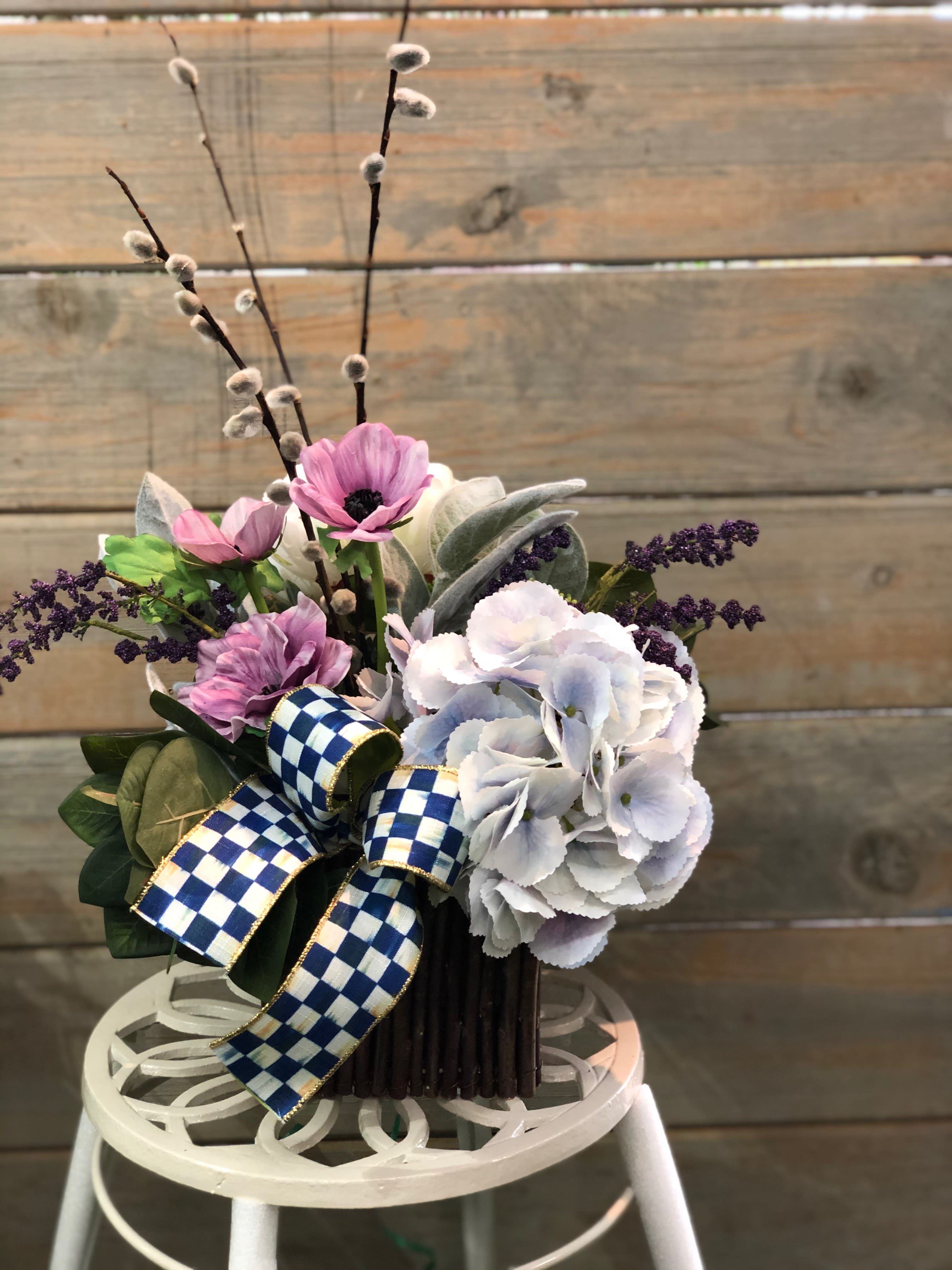 Bouquet of pink and white flowers with a blue checkered ribbon