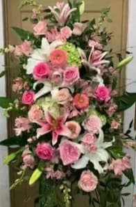 Tall pink and white floral arrangement with lilies and roses