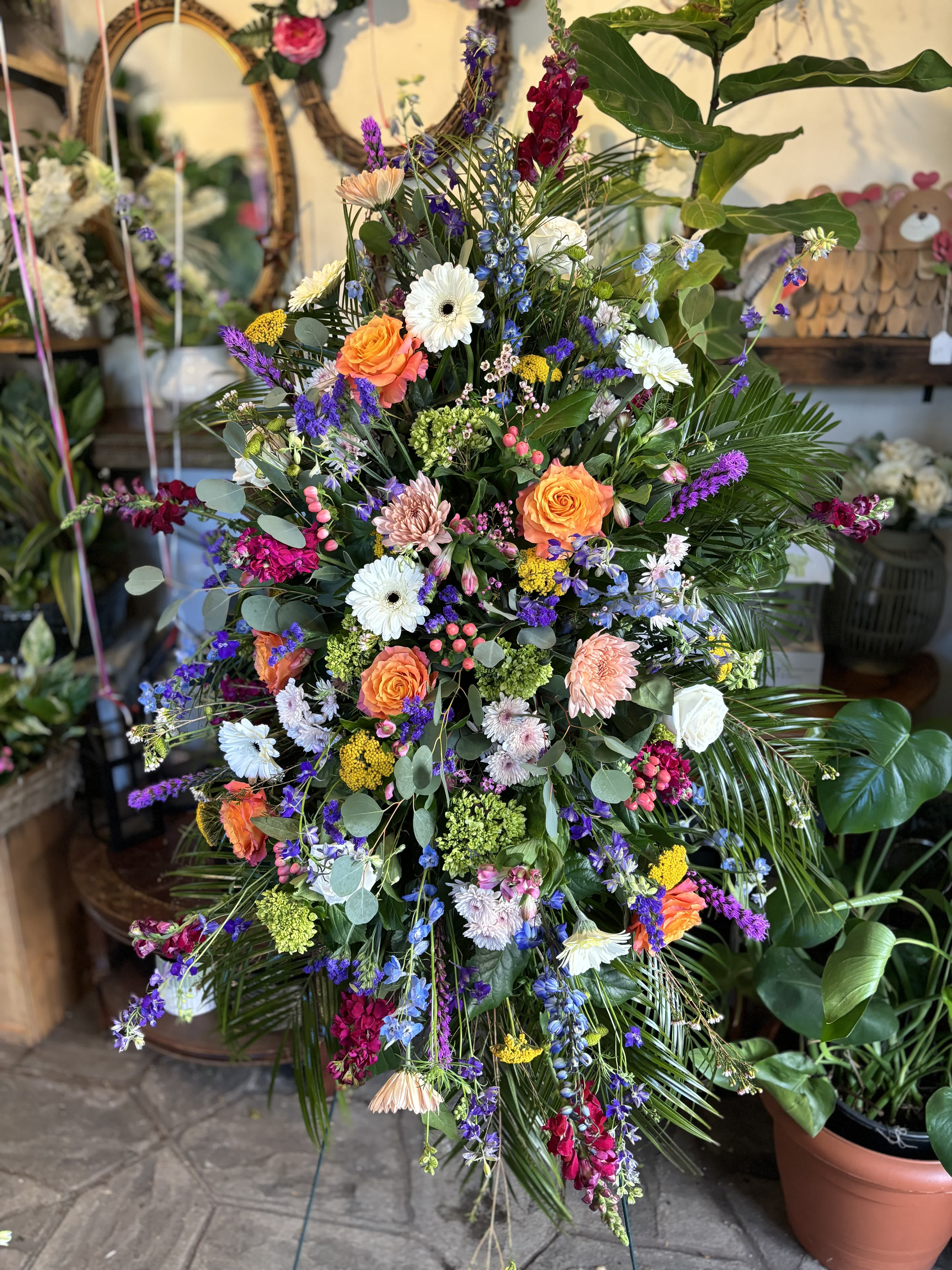 Large mixed flower spray with orange roses and white daisies