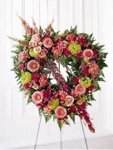 Heart-shaped floral standing spray with pink and red blooms