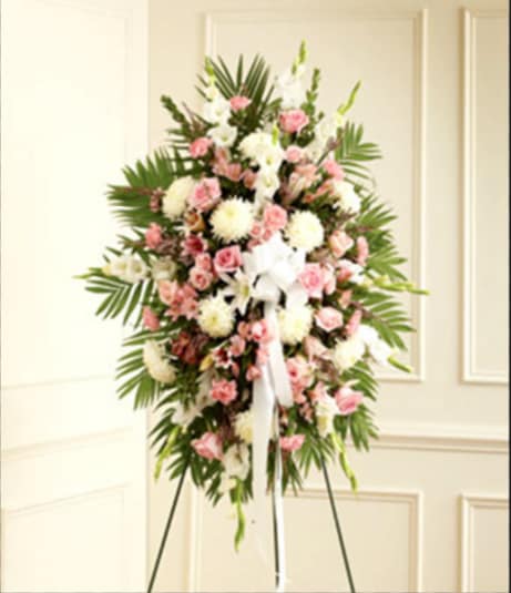Standing floral spray with pink and white flowers on an easel