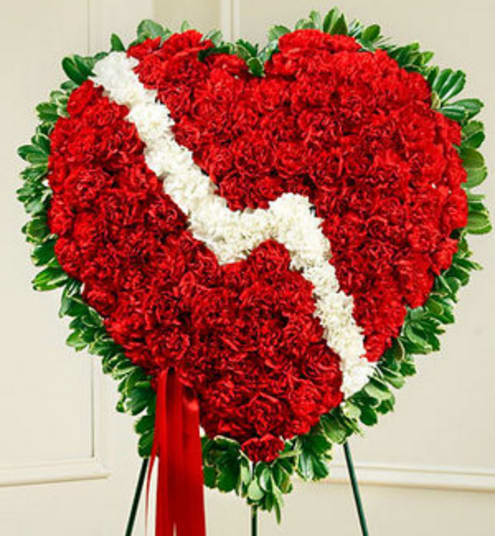 Heart-shaped red floral wreath with a white diagonal ribbon and green border
