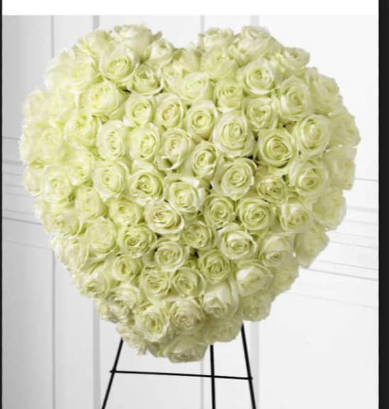 Heart-shaped arrangement of pale cream roses on a stand