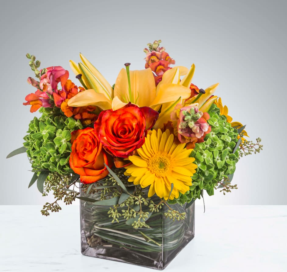 Citrus Splash by BloomNation™ - This bright yellow, green, and orange arrangement includes roses, daisies, and lilies. Citrus Splash by BloomNation™ is the perfect gift for a birthday, thank you, or Cinco De Mayo.   APPROXIMATE DIMENSIONS 14" W X 14" H