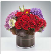 Garnet by BloomNation™ - This deep jewel tone arrangement featuring red roses, purple hydrangea and purple lisianthus is a dream. Garnets symbolize higher thinking and are the birthstone for January making this a great wintertime birthday present or congratulations for an academic or career win.  Approximate Dimensions: 11"D x 11"H