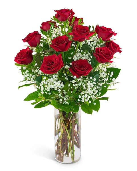 Red roses with baby's breath in a clear glass vase