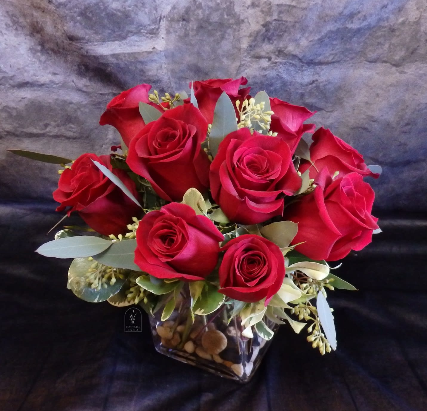 Bouquet of red roses in a clear square vase