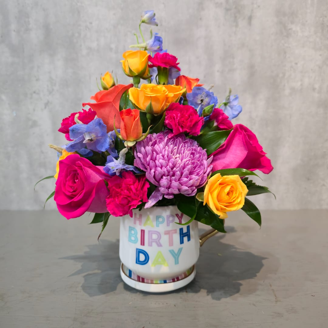 Colorful mixed bouquet in a birthday mug vase