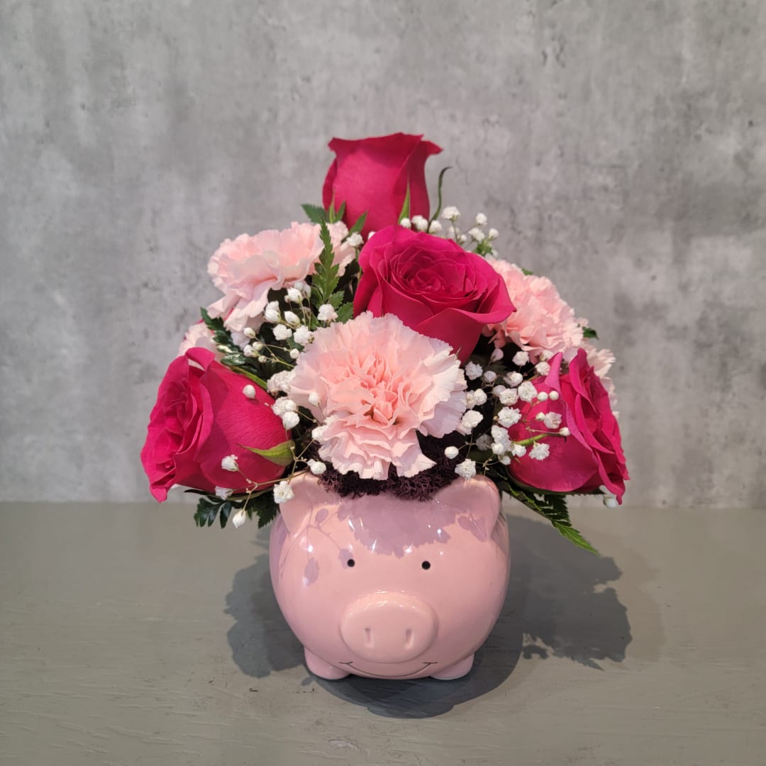 Pink roses and carnations in a pig-shaped vase