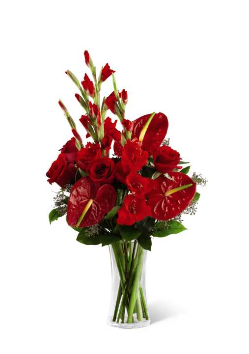 The FTD We Fondly Remember Bouquet - The FTD We Fondly Remember Bouquet is an expression of endless love in this time of loss and grief. Whether sending this bouquet to honor the deceased at their final service or to comfort a friend or family member for their loss, this arrangement of rich red roses, gladiolus and anthurium, offset by lush greens and arriving in a clear glass vase, will convey your warmest sentiments with each exquisite bloom.