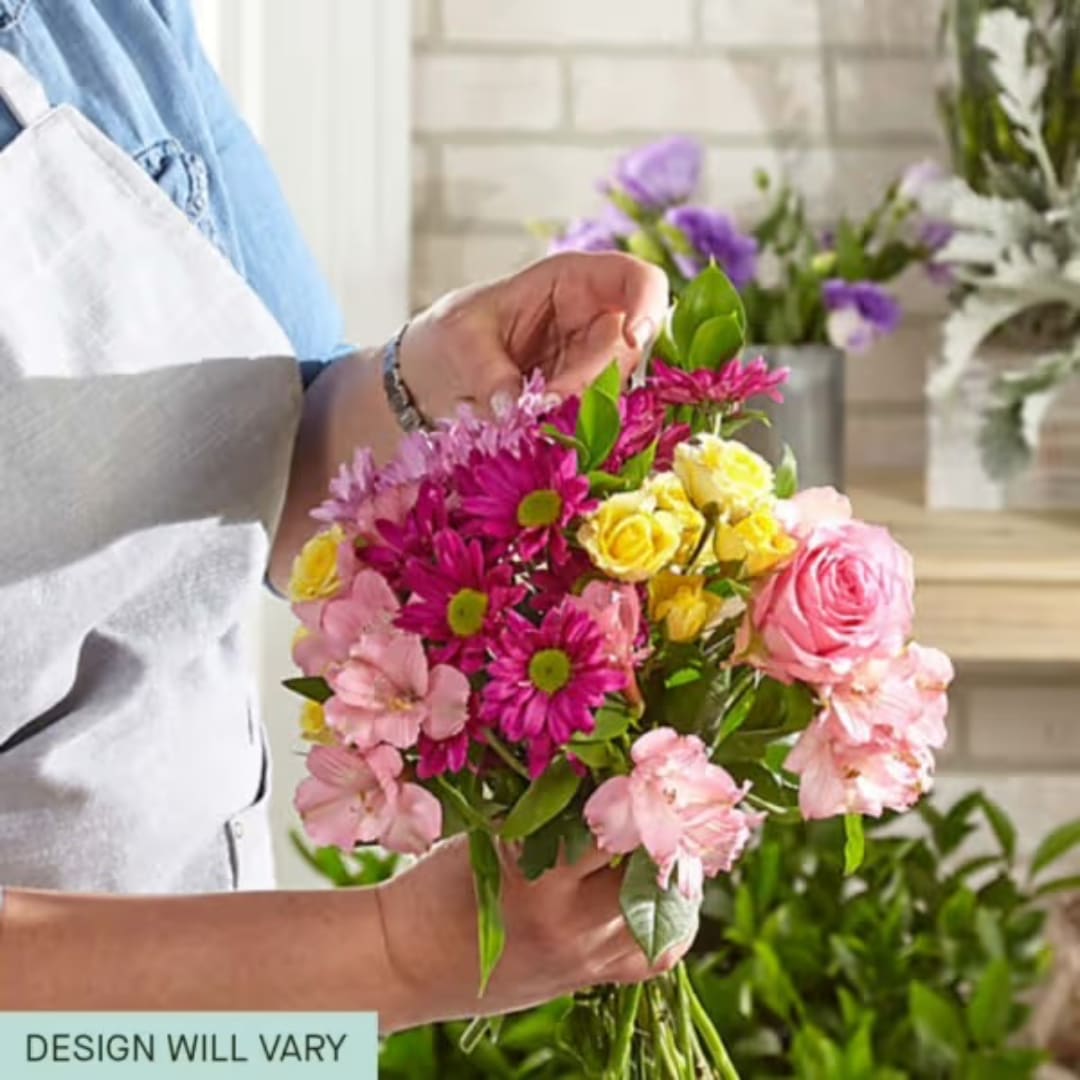 Handheld bouquet of pink, yellow, and purple flowers