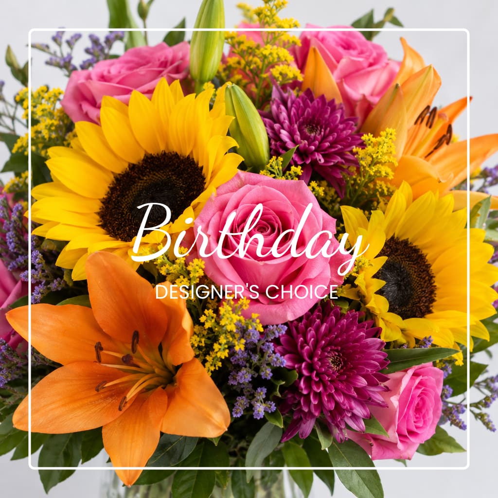 Bright mixed bouquet with sunflowers, pink roses, orange lilies, and purple mums
