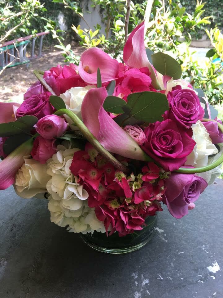 Pink and white bouquet with calla lilies, roses, and hydrangeas in a glass vase
