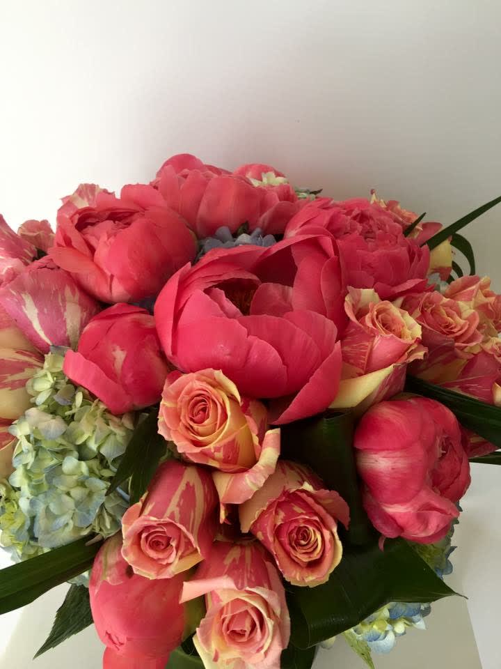 Pink peonies and variegated roses in a bouquet