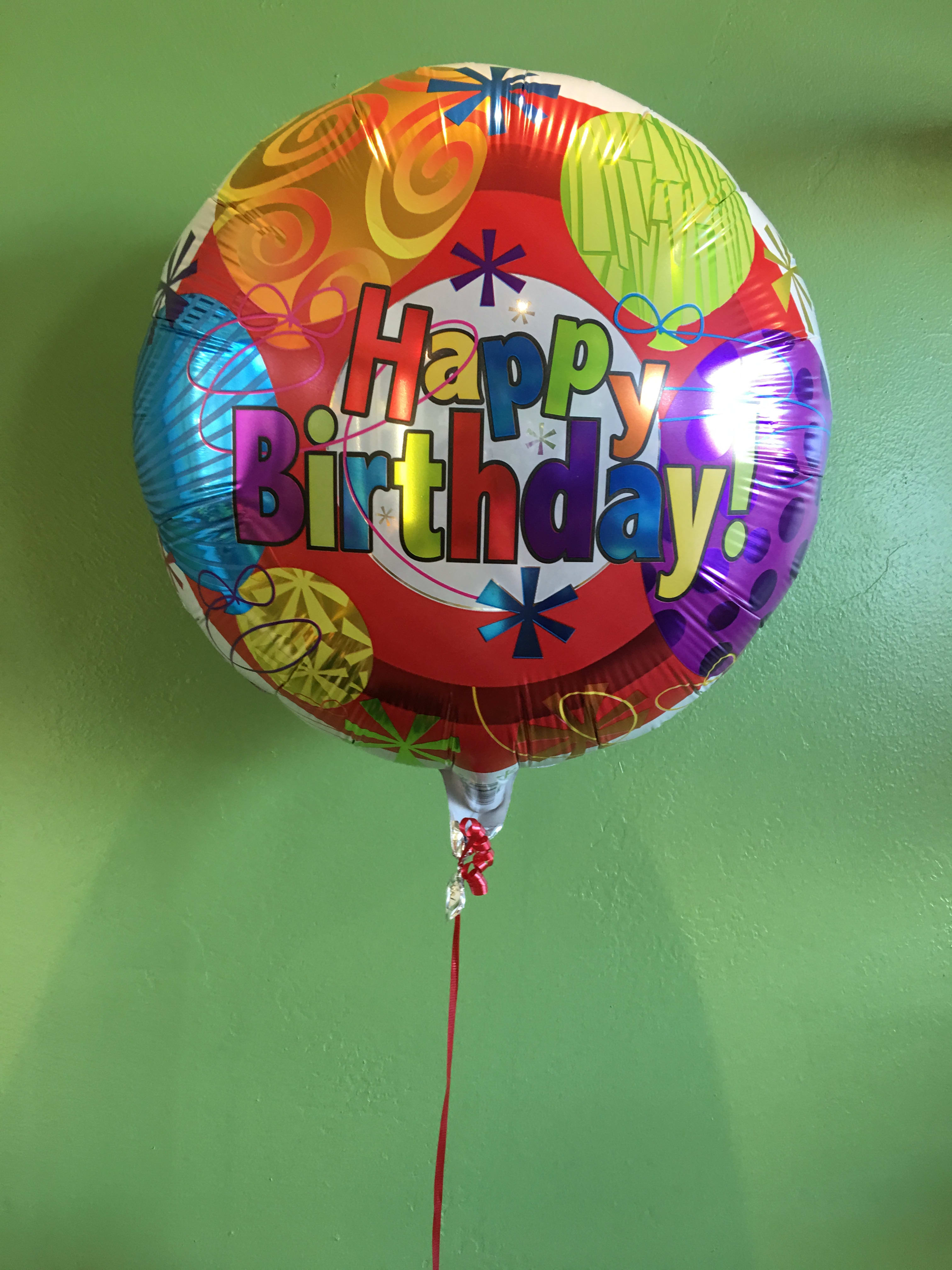 Round birthday balloon with colorful "Happy Birthday!" text