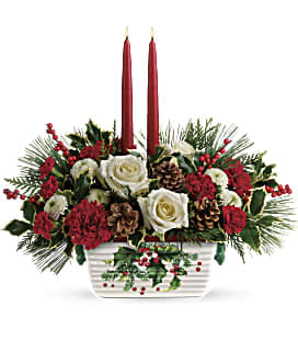  T18X100A Teleflora’s Halls of Holly Centerpiece - The holiday table shines with this festive centerpiece of roses and winter greens, artfully arranged inside an oven-to-table stoneware serving dish that's hand-painted with a classic holly motif!