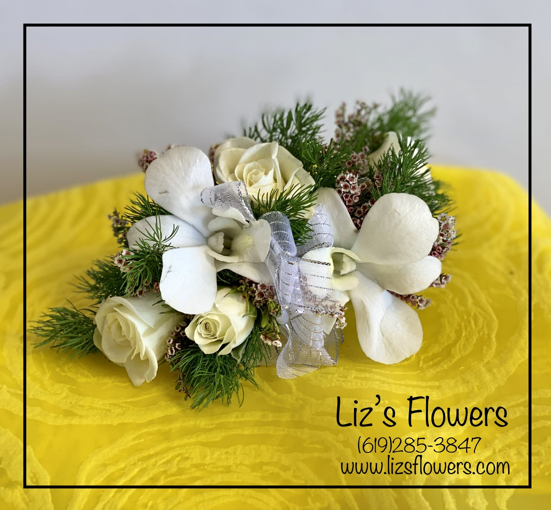 White Rose and Orchid Corsage - A traditional design of precious white flowers, perfect for the mother of the bride or the groom, or any honored guest.