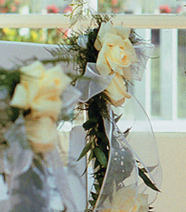 Cream roses with white ribbon on a floral garland