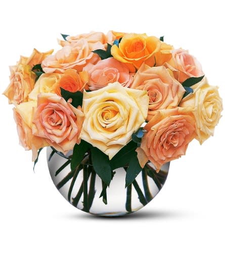 Bouquet of peach and yellow roses in a round glass vase