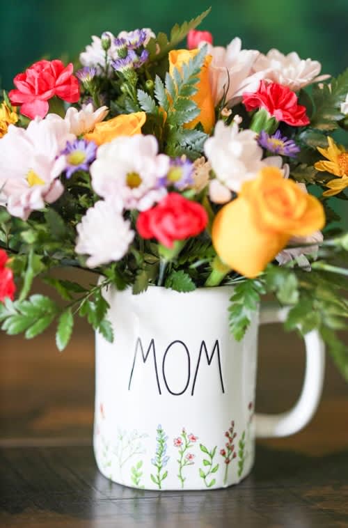 Mixed bouquet in a white mug labeled MOM