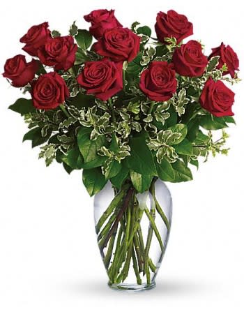 Red roses arranged in a clear glass vase